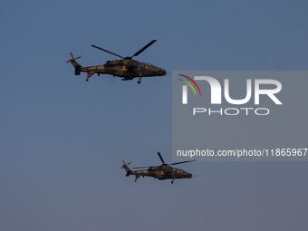 Indian army helicopters display maneuvers during a practice ahead of the Vijay Diwas celebration in Kolkata, India, on December 14, 2024. (