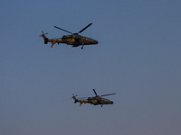 Indian army helicopters display maneuvers during a practice ahead of the Vijay Diwas celebration in Kolkata, India, on December 14, 2024. (