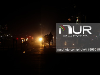 A man rides a horse cart on a cold winter evening in Sopore, Jammu and Kashmir, India, on December 14, 2024. (