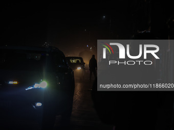 A man walks during a cold winter evening in Sopore, Jammu and Kashmir, India, on December 14, 2024. (