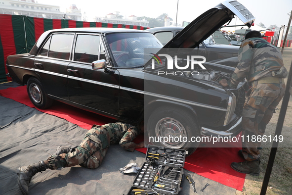 Indian Army personnel repair a vintage car during the full dress rehearsal ahead of ''Vijay Diwas,'' a ceremony to celebrate the liberation...