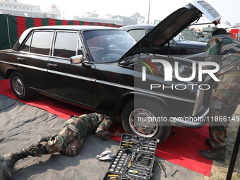 Indian Army personnel repair a vintage car during the full dress rehearsal ahead of ''Vijay Diwas,'' a ceremony to celebrate the liberation...