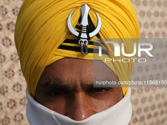 An Indian Army personnel waits before performing during the full dress rehearsal ahead of ''Vijay Diwas,'' a ceremony to celebrate the liber...