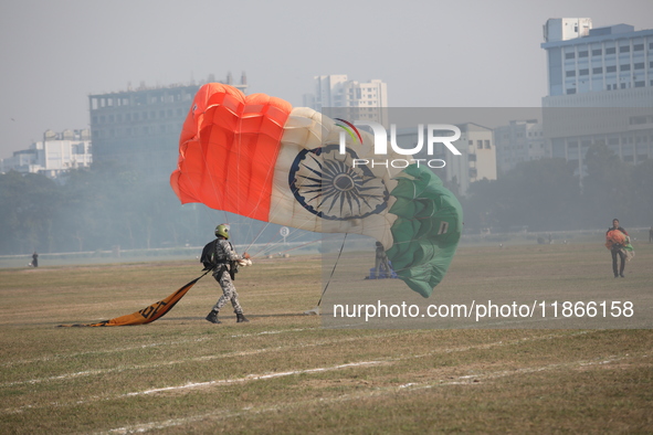 An Indian army paratrooper jumps from a plane carrying an Indian national flag during the full dress rehearsal ahead of ''Vijay Diwas,'' a c...