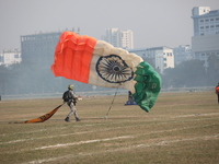 An Indian army paratrooper jumps from a plane carrying an Indian national flag during the full dress rehearsal ahead of ''Vijay Diwas,'' a c...