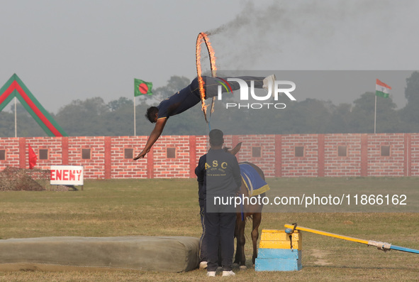 An Indian army soldier performs a stunt during the full dress rehearsal ahead of ''Vijay Diwas,'' a ceremony to celebrate the liberation of...