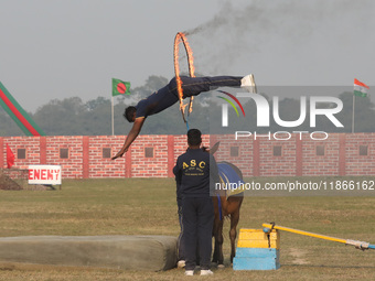 An Indian army soldier performs a stunt during the full dress rehearsal ahead of ''Vijay Diwas,'' a ceremony to celebrate the liberation of...