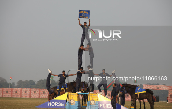 Indian army soldiers perform a stunt during the full dress rehearsal ahead of ''Vijay Diwas,'' a ceremony to celebrate the liberation of Ban...