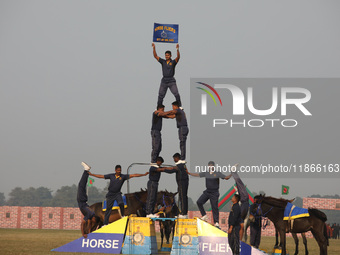 Indian army soldiers perform a stunt during the full dress rehearsal ahead of ''Vijay Diwas,'' a ceremony to celebrate the liberation of Ban...