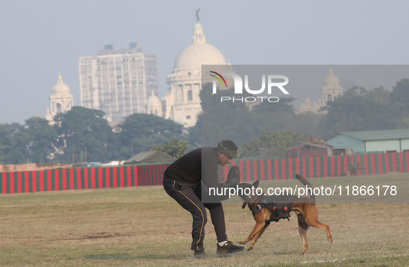 An Indian army soldier with a dog performs a skill during the full dress rehearsal ahead of ''Vijay Diwas,'' a ceremony to celebrate the lib...