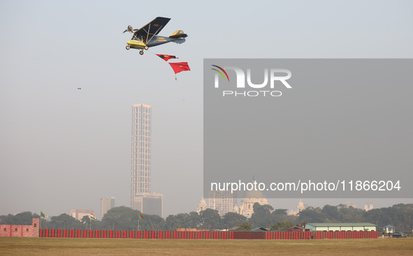 A plane flies past the iconic Victoria Memorial during the full dress rehearsal ahead of ''Vijay Diwas,'' a ceremony to celebrate the libera...