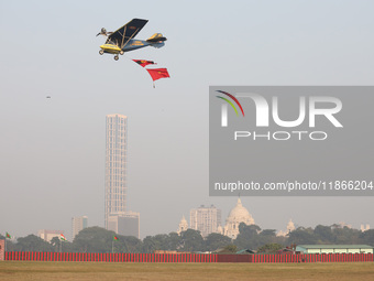 A plane flies past the iconic Victoria Memorial during the full dress rehearsal ahead of ''Vijay Diwas,'' a ceremony to celebrate the libera...