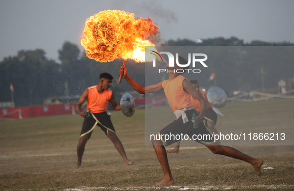 An Indian army soldier blows fire from his mouth as he performs during the full dress rehearsal ahead of ''Vijay Diwas'', a ceremony to cele...