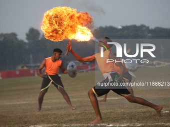 An Indian army soldier blows fire from his mouth as he performs during the full dress rehearsal ahead of ''Vijay Diwas'', a ceremony to cele...