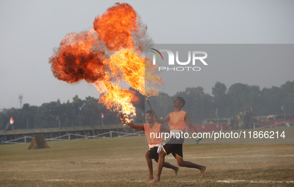 Indian army soldiers blow fire from their mouths as they perform during the full dress rehearsal ahead of ''Vijay Diwas,'' a ceremony to cel...