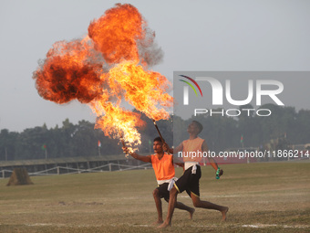 Indian army soldiers blow fire from their mouths as they perform during the full dress rehearsal ahead of ''Vijay Diwas,'' a ceremony to cel...