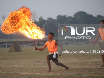 An Indian army soldier blows fire from his mouth as he performs during the full dress rehearsal ahead of ''Vijay Diwas'', a ceremony to cele...