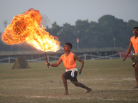 An Indian army soldier blows fire from his mouth as he performs during the full dress rehearsal ahead of ''Vijay Diwas'', a ceremony to cele...