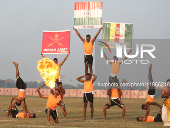 Indian army soldiers perform a stunt during the full dress rehearsal ahead of ''Vijay Diwas,'' a ceremony to celebrate the liberation of Ban...