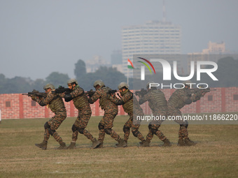 Indian army soldiers demonstrate their skills during the full dress rehearsal ahead of ''Vijay Diwas,'' a ceremony to celebrate the liberati...