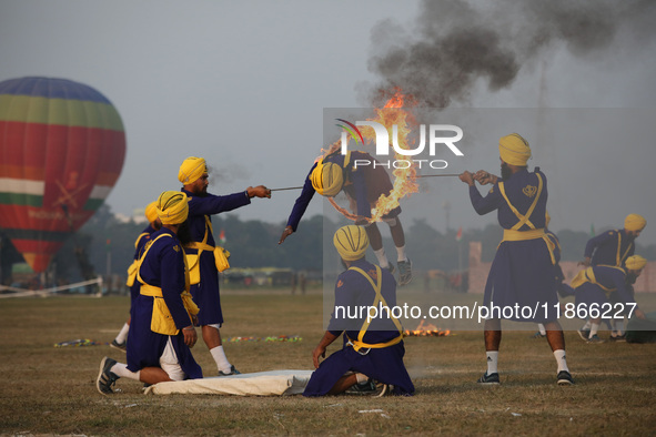 An Indian army soldier performs a stunt during the full dress rehearsal ahead of ''Vijay Diwas,'' a ceremony to celebrate the liberation of...