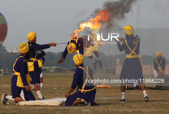 An Indian army soldier performs a stunt during the full dress rehearsal ahead of ''Vijay Diwas,'' a ceremony to celebrate the liberation of...