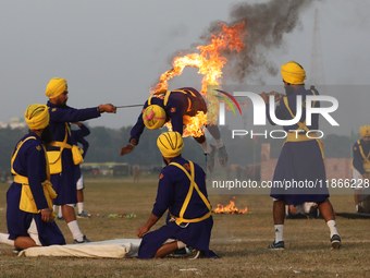 An Indian army soldier performs a stunt during the full dress rehearsal ahead of ''Vijay Diwas,'' a ceremony to celebrate the liberation of...