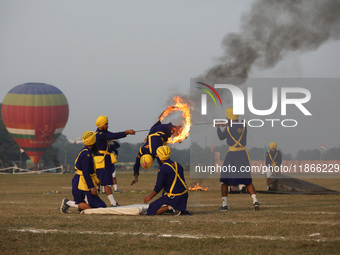 An Indian army soldier performs a stunt during the full dress rehearsal ahead of ''Vijay Diwas,'' a ceremony to celebrate the liberation of...