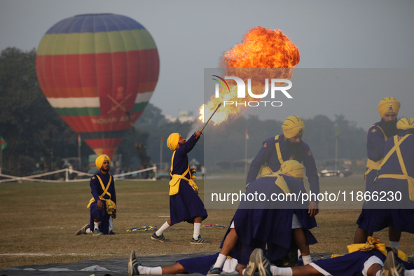 An Indian army soldier performs a stunt during the full dress rehearsal ahead of ''Vijay Diwas,'' a ceremony to celebrate the liberation of...