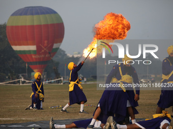 An Indian army soldier performs a stunt during the full dress rehearsal ahead of ''Vijay Diwas,'' a ceremony to celebrate the liberation of...