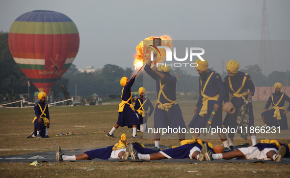 An Indian army soldier performs a stunt during the full dress rehearsal ahead of ''Vijay Diwas,'' a ceremony to celebrate the liberation of...