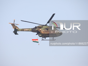 An Indian army helicopter carries an Indian national flag ahead of the full dress rehearsal for ''Vijay Diwas,'' a ceremony to celebrate the...