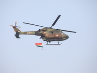 An Indian army helicopter carries an Indian national flag ahead of the full dress rehearsal for ''Vijay Diwas,'' a ceremony to celebrate the...