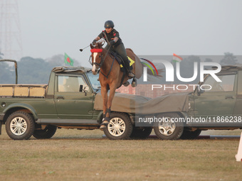 An Indian army soldier demonstrates skills with a horse during the full dress rehearsal ahead of ''Vijay Diwas,'' a ceremony to celebrate th...