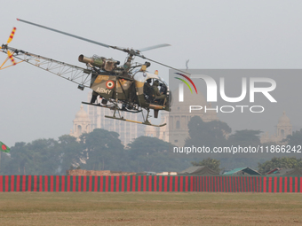 An Indian army soldier demonstrates his skill with a helicopter while flying past the iconic Victoria Memorial during the full dress rehears...