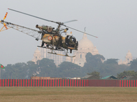 An Indian army soldier demonstrates his skill with a helicopter while flying past the iconic Victoria Memorial during the full dress rehears...