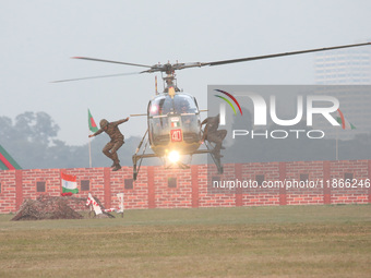 Indian army soldiers demonstrate their skills with a helicopter during the full dress rehearsal ahead of ''Vijay Diwas,'' a ceremony to cele...