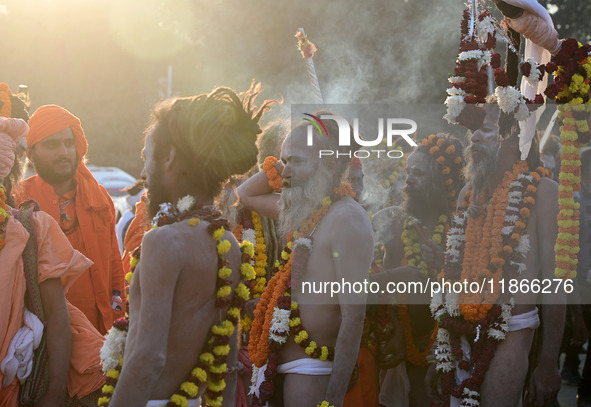 Hindu sadhus (holy men) from the Juna Akhara take part in a religious procession towards the Sangam area during the first entry for the Maha...