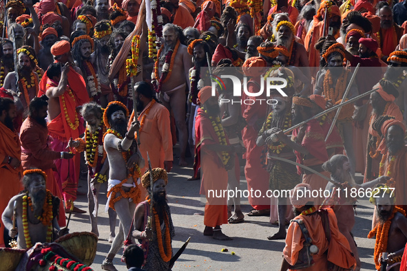 Hindu sadhus (holy men) from the Juna Akhara take part in a religious procession towards the Sangam area during the first entry for the Maha...