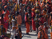 Hindu sadhus (holy men) from the Juna Akhara take part in a religious procession towards the Sangam area during the first entry for the Maha...