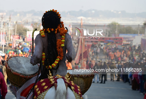 Hindu sadhus (holy men) from the Juna Akhara take part in a religious procession towards the Sangam area during the first entry for the Maha...