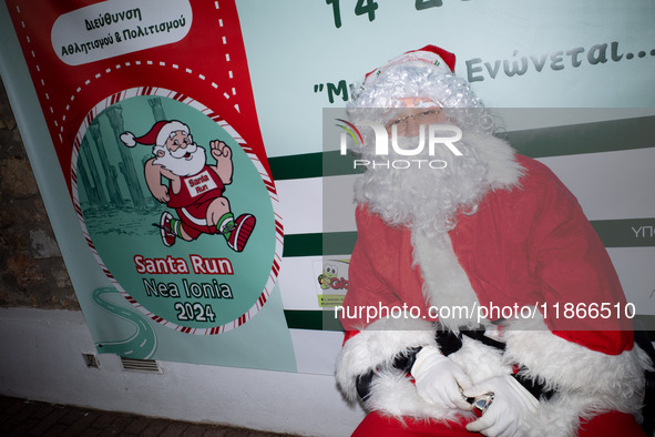 People wearing Santa Claus costumes participate in the annual Santa Run in Athens, Greece, on December 14, 2024. 