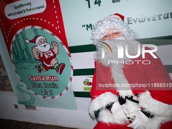 People wearing Santa Claus costumes participate in the annual Santa Run in Athens, Greece, on December 14, 2024. (