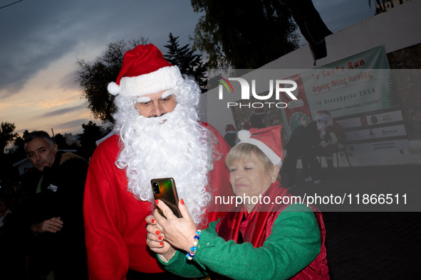 People wearing Santa Claus costumes participate in the annual Santa Run in Athens, Greece, on December 14, 2024. 