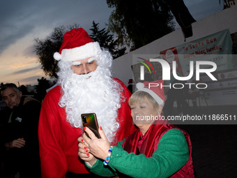 People wearing Santa Claus costumes participate in the annual Santa Run in Athens, Greece, on December 14, 2024. (