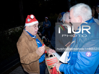 People wearing Santa Claus costumes participate in the annual Santa Run in Athens, Greece, on December 14, 2024. (