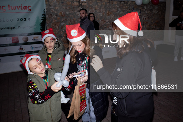 People wearing Santa Claus costumes participate in the annual Santa Run in Athens, Greece, on December 14, 2024. 