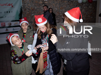 People wearing Santa Claus costumes participate in the annual Santa Run in Athens, Greece, on December 14, 2024. (