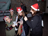 People wearing Santa Claus costumes participate in the annual Santa Run in Athens, Greece, on December 14, 2024. (