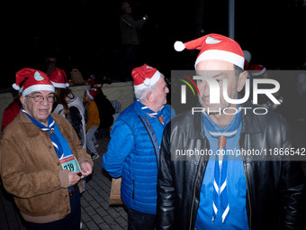 People wearing Santa Claus costumes participate in the annual Santa Run in Athens, Greece, on December 14, 2024. (